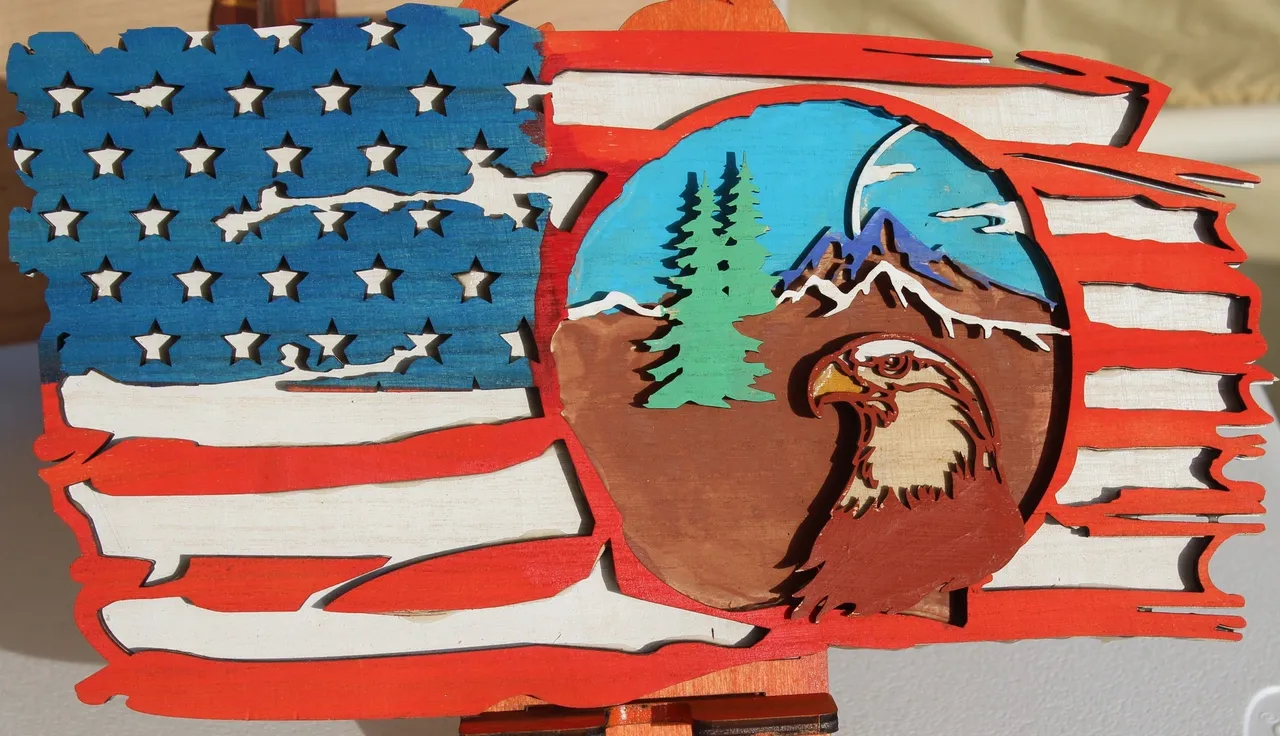 A painting of an eagle and the american flag.