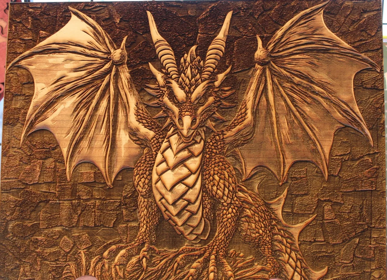 A dragon with wings and horns is depicted in this picture.