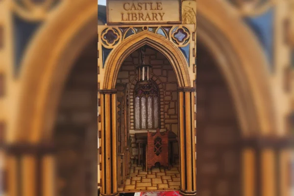 A castle library with a wooden arch and a small organ.