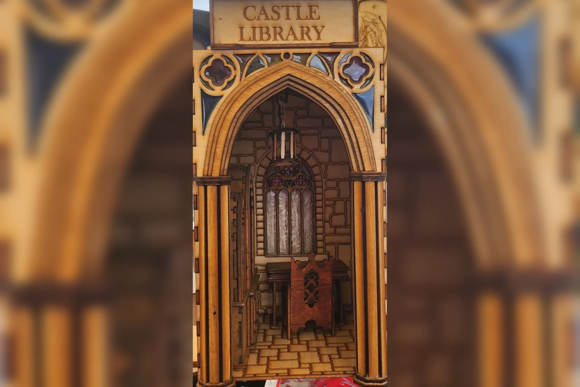 A castle library with a wooden arch and a small organ.