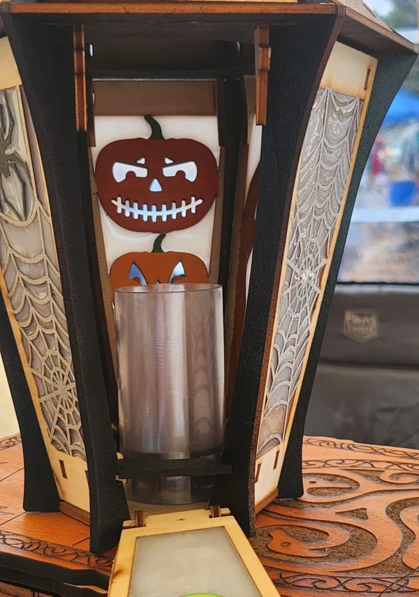 A candle holder with some halloween decorations on it