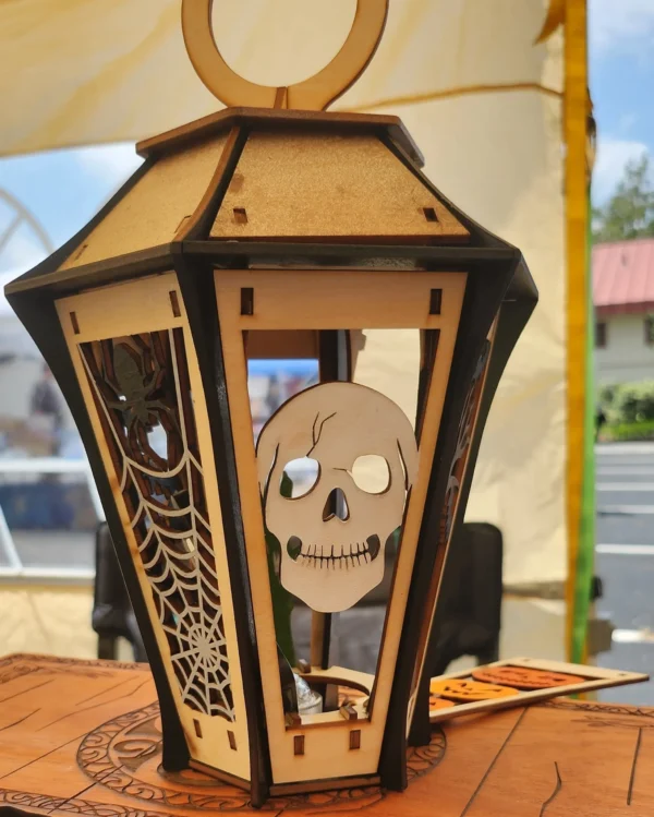 A wooden lantern with a skull on it.