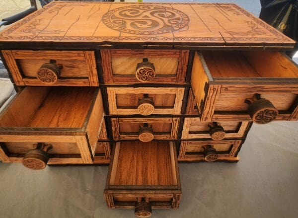 A wooden cabinet with many drawers and compartments.