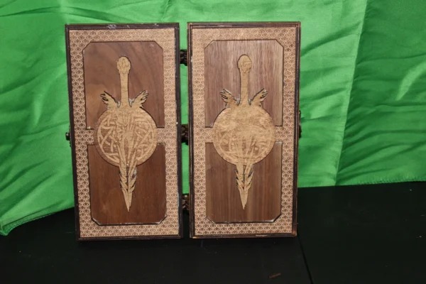 A pair of wooden cabinets with decorative designs on them.