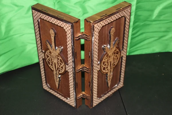 A wooden book with two doors and a sword on the front.