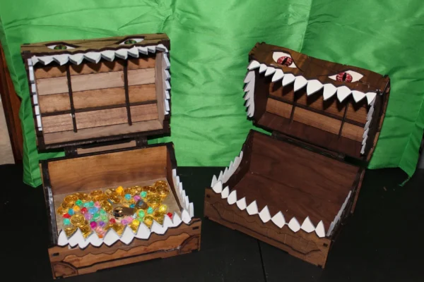 Two wooden boxes with a shark mouth on top of them.