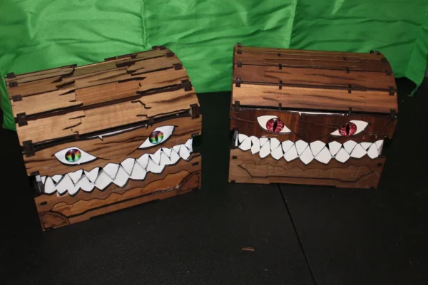 Two wooden boxes with faces painted on them.