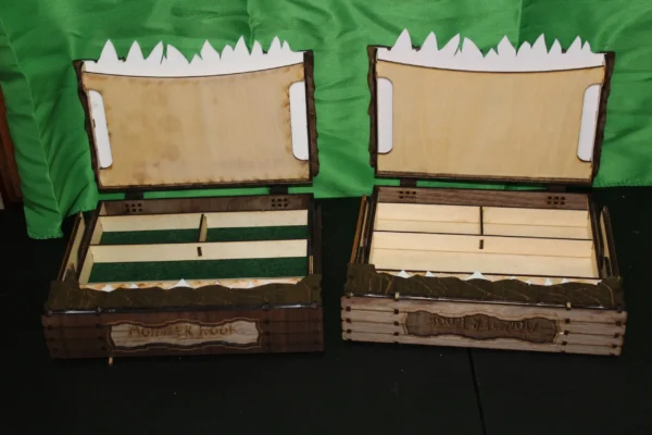 Two wooden trunks with a green cloth behind them.