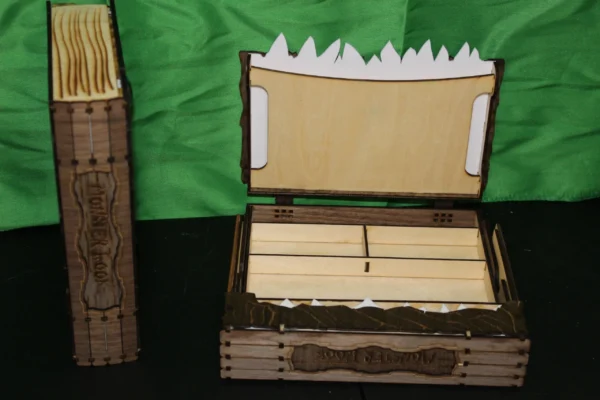 A wooden box with a lid open and a green background.