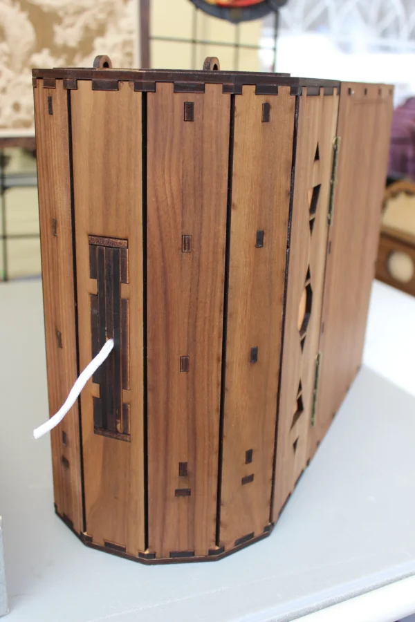 A wooden box with some string attached to it